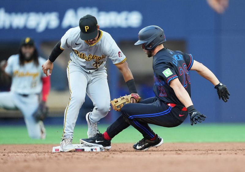 May 31, 2024; Toronto, Ontario, CAN; Pittsburgh Pirates second baseman Nick Gonzales (39) tags out Toronto Blue Jays third baseman Ernie Clement (28) at second base during the third inning at Rogers Centre. Mandatory Credit: Nick Turchiaro-USA TODAY Sports