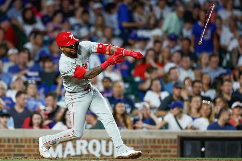 Jul 3, 2024; Chicago, Illinois, USA; Philadelphia Phillies shortstop Edmundo Sosa (33) looses his bat during the sixth inning of a baseball game against the Chicago Cubs at Wrigley Field. Mandatory Credit: Kamil Krzaczynski-USA TODAY Sports