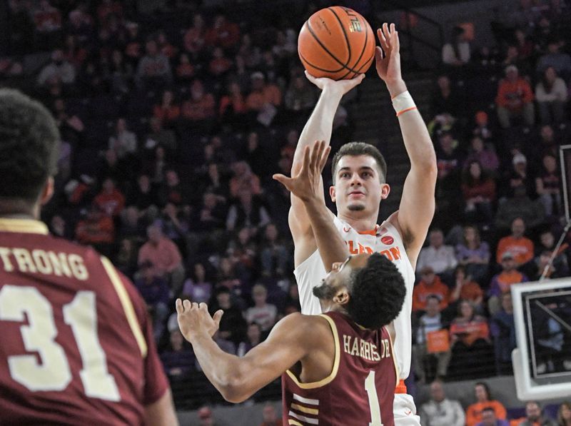 Jan 13, 2024; Clemson, South Carolina, USA; Clemson Tigers guard Joseph Girard III shoots the ball against Boston College Eagles guard Claudell Harris Jr. (1) during the first half at Littlejohn Coliseum. Mandatory Credit: Ken Ruinard-USA TODAY Sports