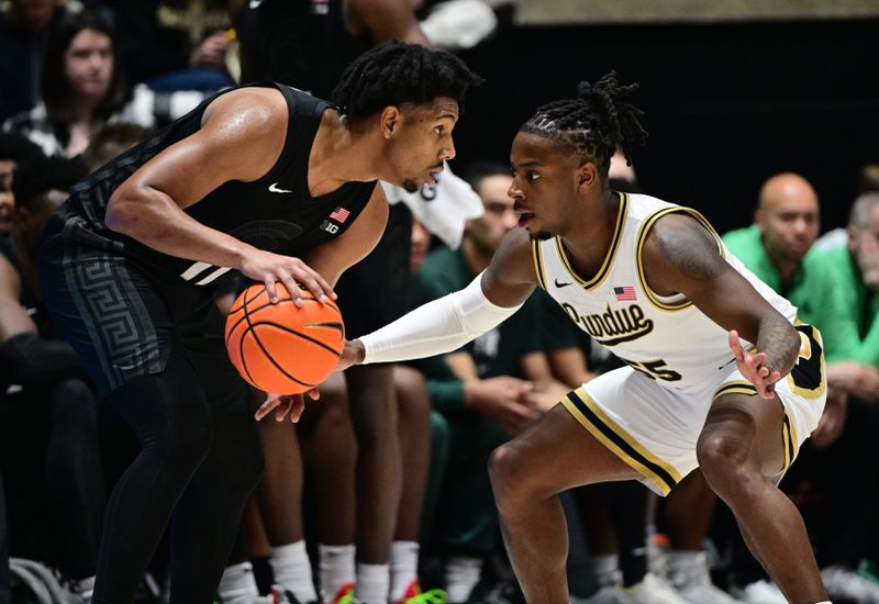 Mar 2, 2024; West Lafayette, Indiana, USA; Purdue Boilermakers guard Lance Jones (55) defends the basket against Michigan State Spartans guard A.J. Hoggard (11) during the second half at Mackey Arena. Mandatory Credit: Marc Lebryk-USA TODAY Sports