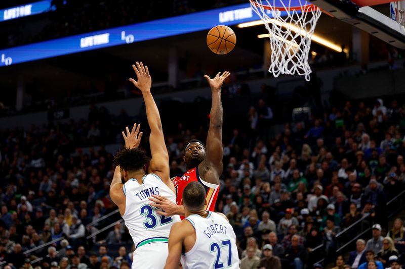 MINNEAPOLIS, MINNESOTA - JANUARY 03: Zion Williamson #1 of the New Orleans Pelicans goes up for a shot while Rudy Gobert #27 and Karl-Anthony Towns #32 of the Minnesota Timberwolves defend in the first quarter at Target Center on January 03, 2024 in Minneapolis, Minnesota. NOTE TO USER: User expressly acknowledges and agrees that, by downloading and or using this photograph, User is consenting to the terms and conditions of the Getty Images License Agreement. (Photo by David Berding/Getty Images)