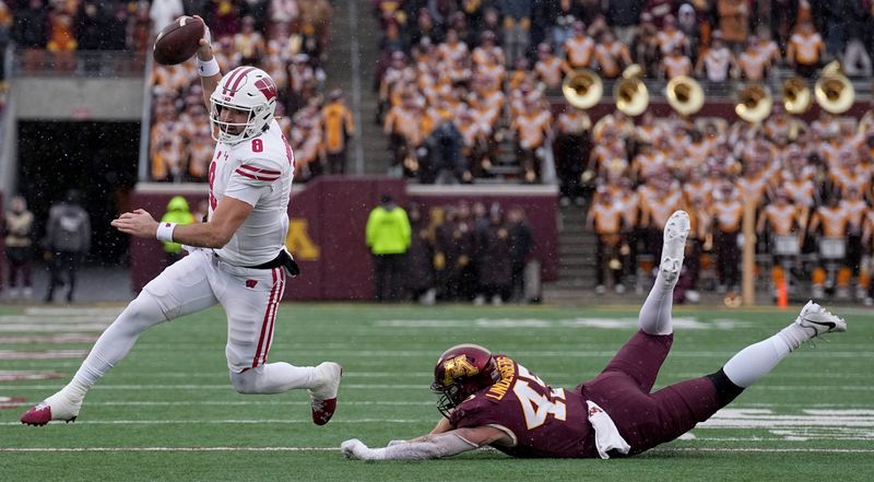 Nov 25, 2023; Minneapolis, Minnesota, USA; Minnesota Golden Gophers linebacker Tyler Stolsky (44) misses a tackle against Wisconsin Badgers quarterback Tanner Mordecai (8) during the third quarter at Huntington Bank Stadium. Mandatory Credit: Mark Hoffman/Milwaukee Journal Sentinel via USA TODAY NETWORK