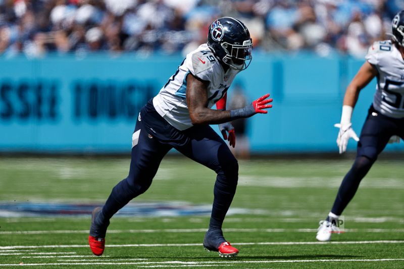 Tennessee Titans linebacker Arden Key (49) rushes during their NFL football against the Los Angeles Chargers game Sunday, Sept. 17, 2023, in Nashville, Tenn. (AP Photo/Wade Payne)