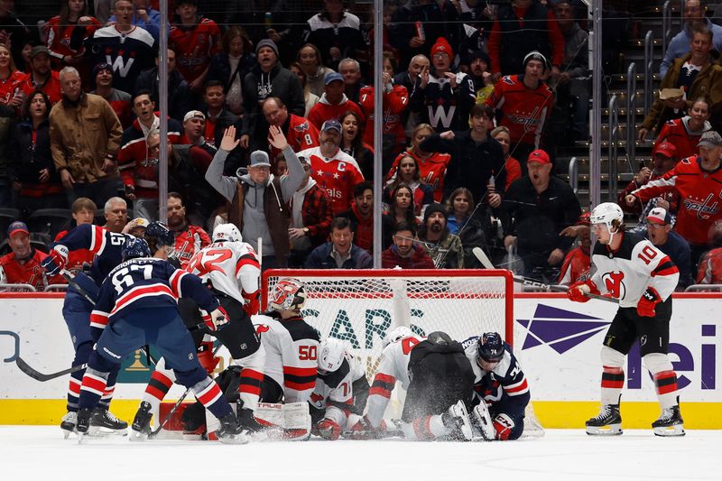 Feb 20, 2024; Washington, District of Columbia, USA; New Jersey Devils goaltender Nico Daws (50) makes a save on Washington Capitals left wing Max Pacioretty (67) in the first period at Capital One Arena. Mandatory Credit: Geoff Burke-USA TODAY Sports