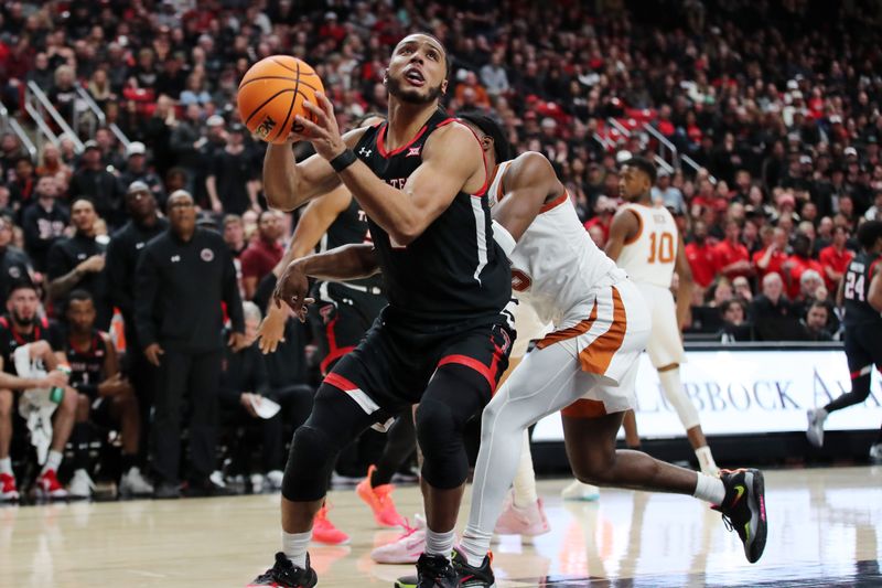 Feb 13, 2023; Lubbock, Texas, USA;  Texas Tech Red Raiders forward Kevin Obanor (0) stops to shoot against Texas Longhorns guard Marcus Carr (5) in the second half at United Supermarkets Arena. Mandatory Credit: Michael C. Johnson-USA TODAY Sports