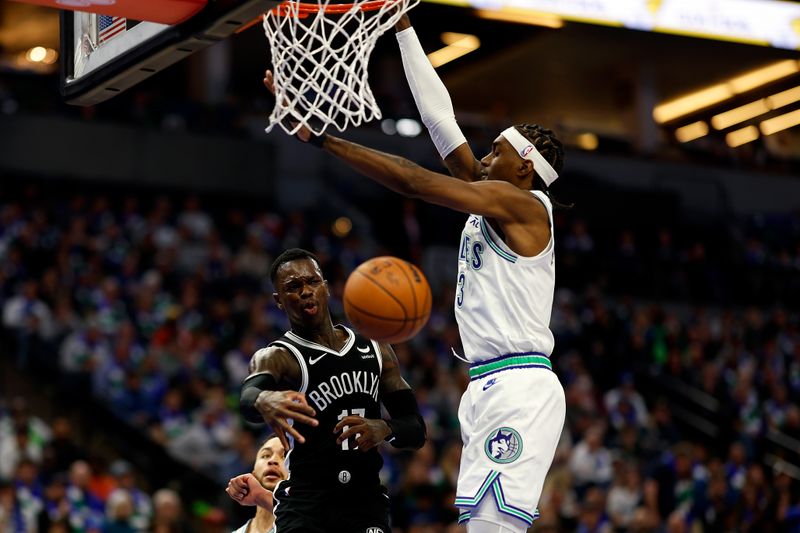 MINNEAPOLIS, MINNESOTA - FEBRUARY 24: Dennis Schroder #17 of the Brooklyn Nets passes the ball against Jaden McDaniels #3 of the Minnesota Timberwolves in the third quarter at Target Center on February 24, 2024 in Minneapolis, Minnesota. The Timberwolves defeated the Nets 101-86. NOTE TO USER: User expressly acknowledges and agrees that, by downloading and or using this photograph, User is consenting to the terms and conditions of the Getty Images License Agreement. (Photo by David Berding/Getty Images)