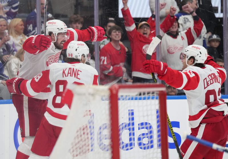 Apr 13, 2024; Toronto, Ontario, CAN; Detroit Red Wings center Dylan Larkin (71) scores the winning goal and celebrates with right wing Patrick Kane (88) against the Toronto Maple Leafs during the overtime period at Scotiabank Arena. Mandatory Credit: Nick Turchiaro-USA TODAY Sports