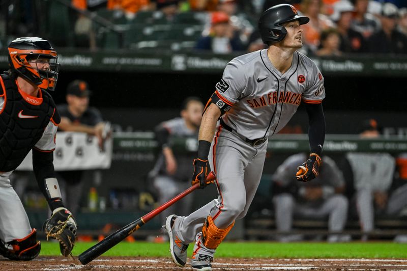 Sep 17, 2024; Baltimore, Maryland, USA;  San Francisco Giants outfielder Mike Yastrzemski (5) swings throws a second inning rbi single against the Baltimore Orioles at Oriole Park at Camden Yards. Mandatory Credit: Tommy Gilligan-Imagn Images