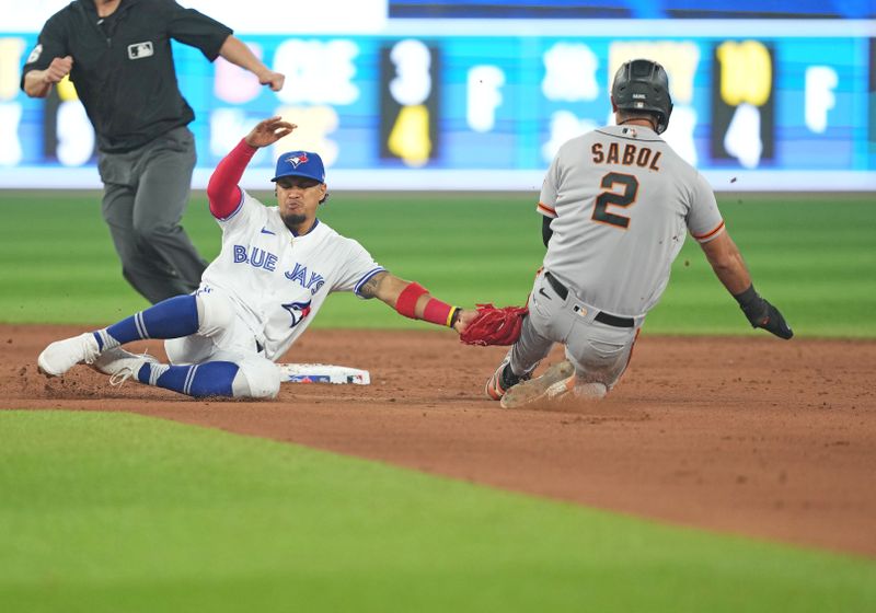 Jun 29, 2023; Toronto, Ontario, CAN; Toronto Blue Jays second baseman Santiago Espinal (5) tags out San Francisco Giants catcher Blake Sabol (2) at second base during the ninth inning at Rogers Centre. Mandatory Credit: Nick Turchiaro-USA TODAY Sports