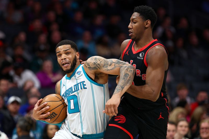 CHARLOTTE, NORTH CAROLINA - FEBRUARY 07: Miles Bridges #0 of the Charlotte Hornets drives to the basket against RJ Barrett #9 of the Toronto Raptors during the second half of the game at Spectrum Center on February 07, 2024 in Charlotte, North Carolina. NOTE TO USER: User expressly acknowledges and agrees that, by downloading and or using this photograph, User is consenting to the terms and conditions of the Getty Images License Agreement. (Photo by Jared C. Tilton/Getty Images)