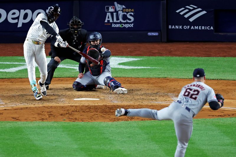 Oct 15, 2024; Bronx, New York, USA; New York Yankees third base Jazz Chisholm Jr. (13) hits a double during the sixth inning against Cleveland Guardians pitcher Erik Sabrowski (62) during the sixth inning in game two of the ALCS for the 2024 MLB Playoffs at Yankee Stadium. Mandatory Credit: Brad Penner-Imagn Images