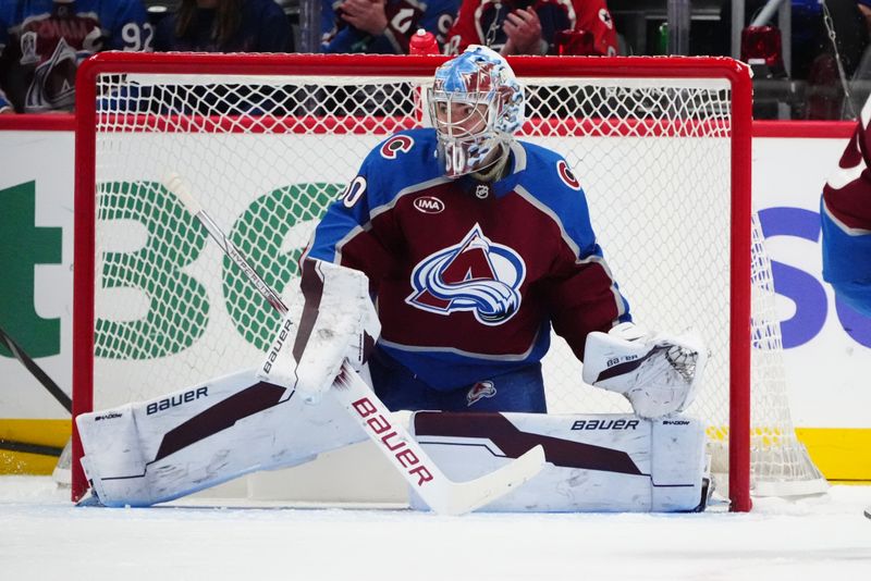 Nov 5, 2024; Denver, Colorado, USA; Colorado Avalanche goaltender Justus Annunen (60) defends during the second period against the Seattle Kraken at Ball Arena. Mandatory Credit: Ron Chenoy-Imagn Images