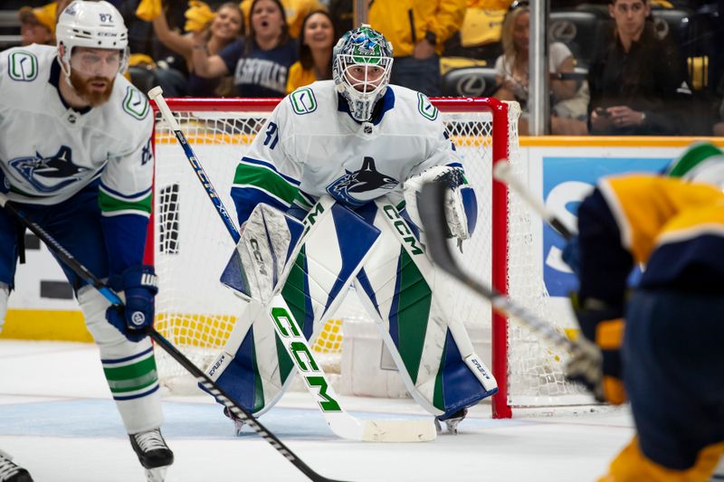 May 3, 2024; Nashville, Tennessee, USA; Vancouver Canucks goalkeeper Vancouver Canucks goalie Arturs Silovs (31) awaits the face off against the Nashville Predators during the first period in game six of the first round of the 2024 Stanley Cup Playoffs at Bridgestone Arena. Mandatory Credit: Steve Roberts-USA TODAY Sports