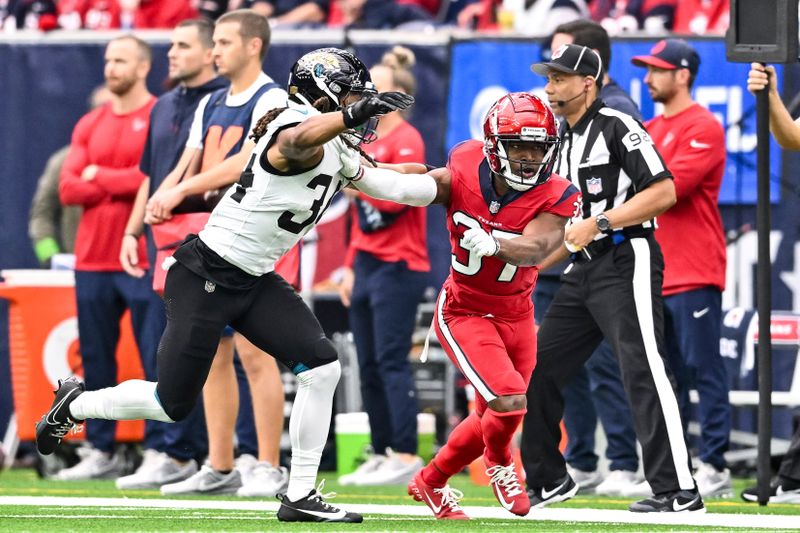 Houston Texans cornerback D'Angelo Ross (37) and Jacksonville Jaguars cornerback Gregory Junior (34) in action during an NFL football game, Sunday, Nov 26, 2023, in Houston. (AP Photo/Maria Lysaker)