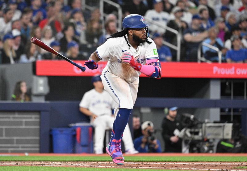 Apr 8, 2024; Toronto, Ontario, CAN;  Toronto Blue Jays first baseman Vladimir Guerrero Jr. (27) hits an RBI double against the Seattle Mariners in the fourth inning at Rogers Centre. Mandatory Credit: Dan Hamilton-USA TODAY Sports