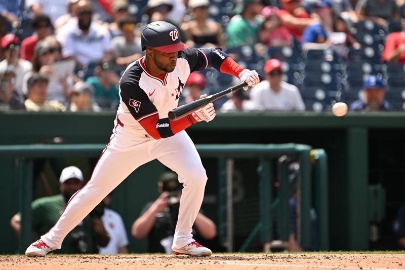 May 26, 2024; Washington, District of Columbia, USA; Washington Nationals center fielder Victor Robles (16) bunts the ball for a hit against the Seattle Mariners during the sixth inning at Nationals Park. Mandatory Credit: Rafael Suanes-USA TODAY Sports