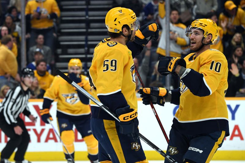 Dec 7, 2023; Nashville, Tennessee, USA; Nashville Predators defenseman Roman Josi (59) celebrates with center Colton Sissons (10) after a goal during the third period against the Tampa Bay Lightning at Bridgestone Arena. Mandatory Credit: Christopher Hanewinckel-USA TODAY Sports