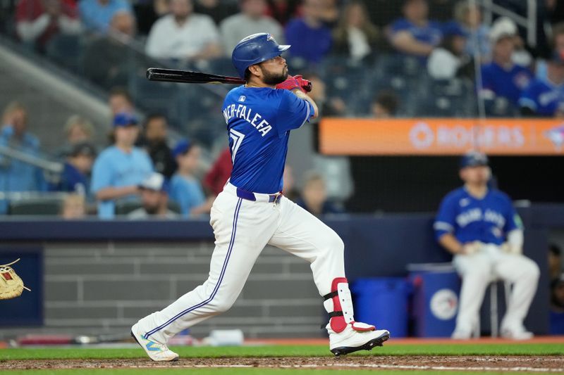 Apr 14, 2024; Toronto, Ontario, CAN; Toronto Blue Jays second baseman Isiah Kiner-Falefa (7) hits a one run single against the Colorado Rockies during the eighth inning at Rogers Centre. Mandatory Credit: John E. Sokolowski-USA TODAY Sports