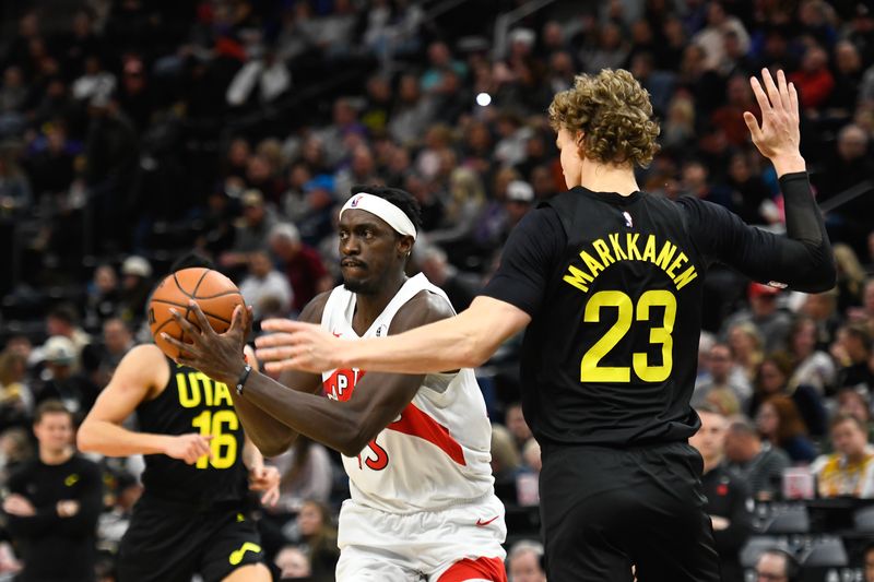 SALT LAKE CITY, UTAH - JANUARY 12: Pascal Siakam #43 of the Toronto Raptors passes around Lauri Markkanen #23 of the Utah Jazz during the second halfof a game at Delta Center on January 12, 2024 in Salt Lake City, Utah. NOTE TO USER: User expressly acknowledges and agrees that, by downloading and or using this photograph, User is consenting to the terms and conditions of the Getty Images License Agreement. (Photo by Alex Goodlett/Getty Images)