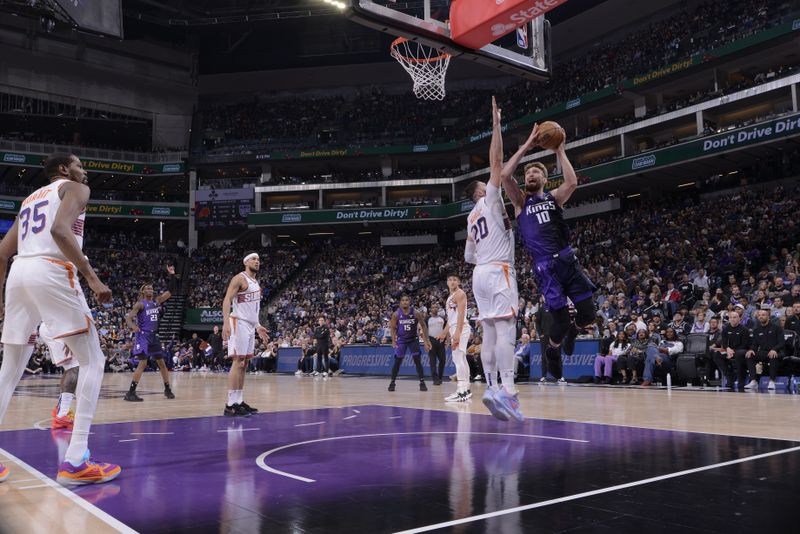 SACRAMENTO, CA - APRIL 12: Domantas Sabonis #10 of the Sacramento Kings drives to the basket during the game against the Phoenix Suns on April 12, 2024 at Golden 1 Center in Sacramento, California. NOTE TO USER: User expressly acknowledges and agrees that, by downloading and or using this Photograph, user is consenting to the terms and conditions of the Getty Images License Agreement. Mandatory Copyright Notice: Copyright 2024 NBAE (Photo by Rocky Widner/NBAE via Getty Images)