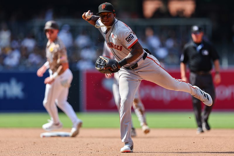 Sep 8, 2024; San Diego, California, USA; San Francisco Giants second baseman Marco Luciano (37) throws out San Diego Padres catcher Kyle Higashioka (20) on a ground ball in the seventh inning at Petco Park. Mandatory Credit: Chadd Cady-Imagn Images