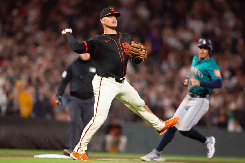 Apr 5, 2025; San Francisco, California, San Francisco Giants third baseman Matt Chapman (26) leaves his feet to throw out Seattle Mariners shortstop J.P. Crawford at first base for a the final out during the ninth inning at Oracle Park. Mandatory Credit: D. Ross Cameron-Imagn Images