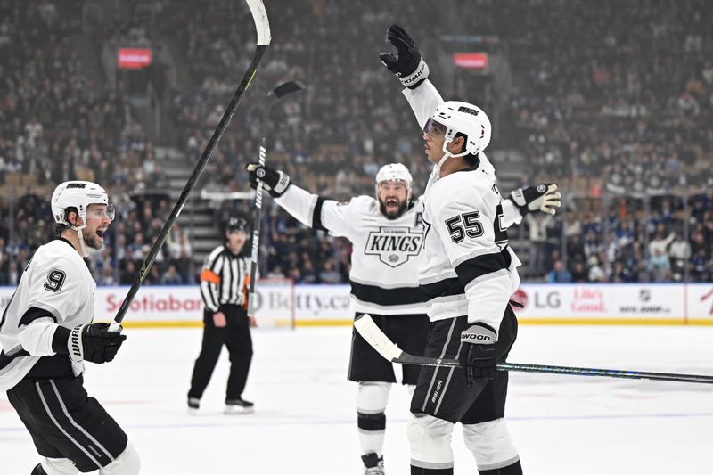Nov 13, 2025; Toronto, Ontario, CAN;  Los Angeles Kings forward Quintin Byfield (55) celebrates with forward Adrian Kempe (9) and defenseman Drew Doughty (8) after scoring the winning goal in overtime against the Toronto Maple Leafs at Scotiabank Arena. Mandatory Credit: Dan Hamilton-Imagn Images