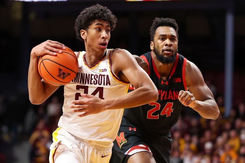 Jan 7, 2024; Minneapolis, Minnesota, USA; Minnesota Golden Gophers guard Cam Christie (24) works towards the basket as Maryland Terrapins forward Donta Scott (24) defends during the first half at Williams Arena. Mandatory Credit: Matt Krohn-USA TODAY Sports