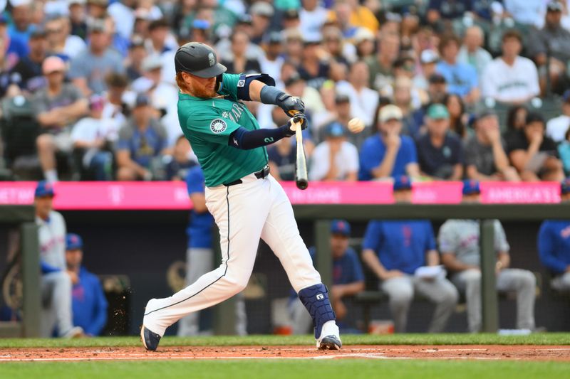 Aug 10, 2024; Seattle, Washington, USA; Seattle Mariners first baseman Justin Turner (2) hits an RBI double against the New York Mets during the first inning at T-Mobile Park. Mandatory Credit: Steven Bisig-USA TODAY Sports