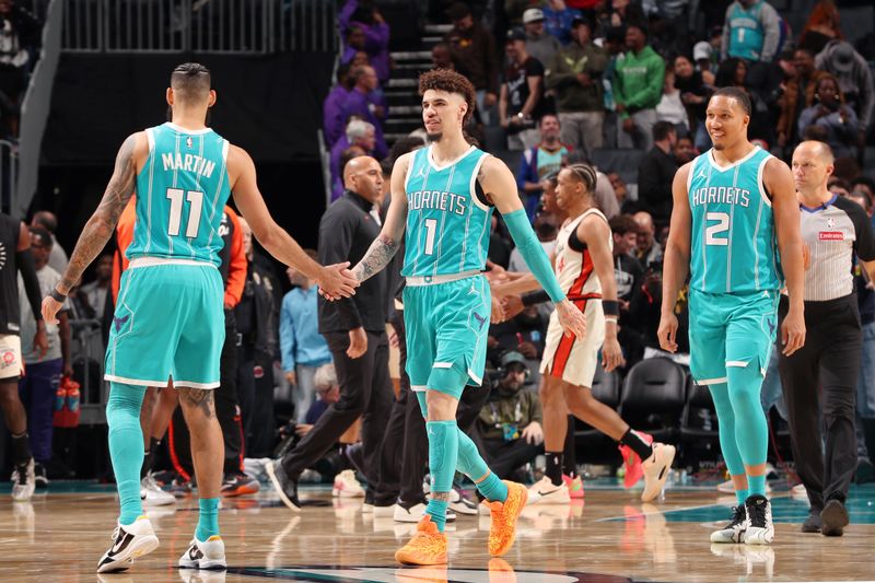 CHARLOTTE, NC - NOVEMBER 21: LaMelo Ball #1 and Cody Martin #11 of the Charlotte Hornets high five during the game against the Detroit Pistons on November 21, 2024 at Spectrum Center in Charlotte, North Carolina. NOTE TO USER: User expressly acknowledges and agrees that, by downloading and or using this photograph, User is consenting to the terms and conditions of the Getty Images License Agreement. Mandatory Copyright Notice: Copyright 2024 NBAE (Photo by Kent Smith/NBAE via Getty Images)