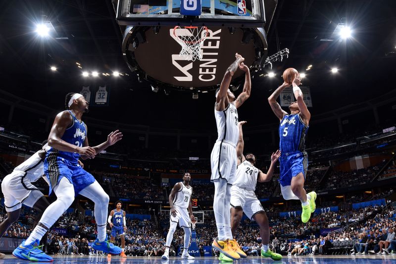 ORLANDO, FL - MARCH 13: Paolo Banchero #5 of the Orlando Magic drives to the basket during the game against the Brooklyn Nets on March 13, 2024 at the Kia Center in Orlando, Florida. NOTE TO USER: User expressly acknowledges and agrees that, by downloading and or using this photograph, User is consenting to the terms and conditions of the Getty Images License Agreement. Mandatory Copyright Notice: Copyright 2024 NBAE (Photo by Fernando Medina/NBAE via Getty Images)