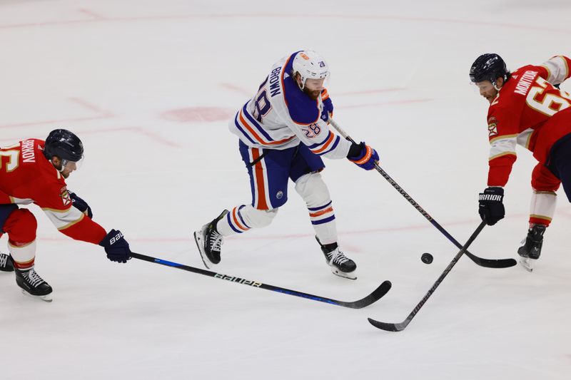 Jun 10, 2024; Sunrise, Florida, USA; Florida Panthers forward Aleksander Barkov (16) and defenseman Brandon Montour (62) defend against Edmonton Oilers forward Connor Brown (28) during the first period in game two of the 2024 Stanley Cup Final at Amerant Bank Arena. Mandatory Credit: Sam Navarro-USA TODAY Sports