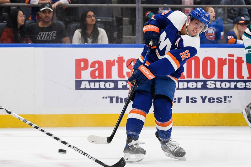 Oct 18, 2022; Elmont, New York, USA; New York Islanders right wing Josh Bailey (12) attempts a shot against the San Jose Sharks during the second period at UBS Arena. Mandatory Credit: Dennis Schneidler-USA TODAY Sports