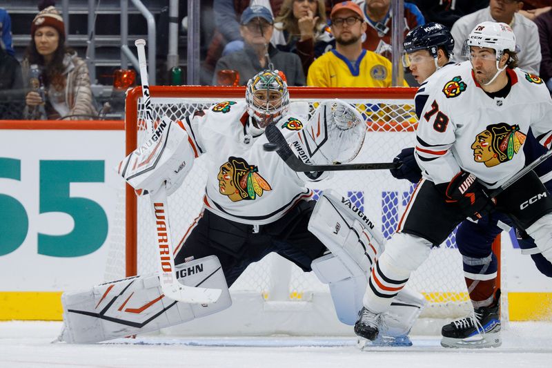 Oct 28, 2024; Denver, Colorado, USA; Colorado Avalanche center Ivan Ivan (82) attempts to deflect the puck in front of Chicago Blackhawks goaltender Petr Mrazek (34) as defenseman TJ Brodie (78) defends in the third period at Ball Arena. Mandatory Credit: Isaiah J. Downing-Imagn Images