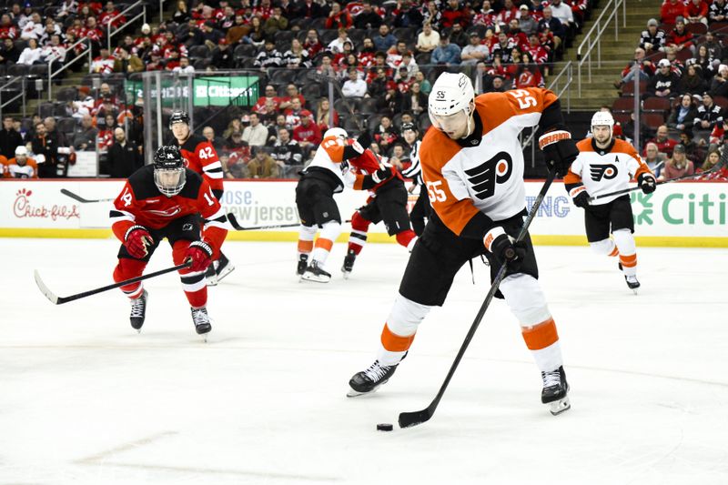 Jan 29, 2025; Newark, New Jersey, USA; Philadelphia Flyers defenseman Rasmus Ristolainen (55) skates with the puck against New Jersey Devils right wing Nathan Bastian (14) during the third period at Prudential Center. Mandatory Credit: John Jones-Imagn Images