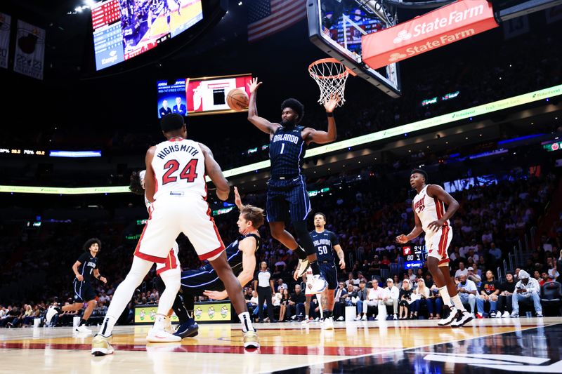 MIAMI, FLORIDA - OCTOBER 23: Jonathan Isaac #1 of the Orlando Magic defends against Haywood Highsmith #24 of the Miami Heat during the second half at Kaseya Center on October 23, 2024 in Miami, Florida. NOTE TO USER: User expressly acknowledges and agrees that, by downloading and or using this photograph, User is consenting to the terms and conditions of the Getty Images License Agreement. (Photo by Carmen Mandato/Getty Images)