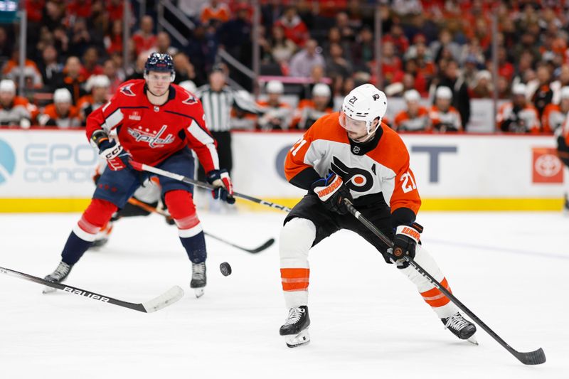 Mar 1, 2024; Washington, District of Columbia, USA; Philadelphia Flyers center Scott Laughton (21) skates with the puck as Washington Capitals center Aliaksei Protas (21) chases in the second period at Capital One Arena. Mandatory Credit: Geoff Burke-USA TODAY Sports