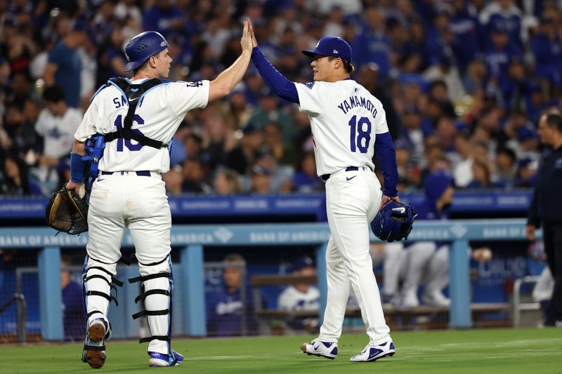 Jun 1, 2024; Los Angeles, California, USA;  Los Angeles Dodgers starting pitcher Yoshinobu Yamamoto (18) is greeted by catcher Will Smith (16) during the sixth inning against the Colorado Rockies at Dodger Stadium. Mandatory Credit: Kiyoshi Mio-USA TODAY Sports