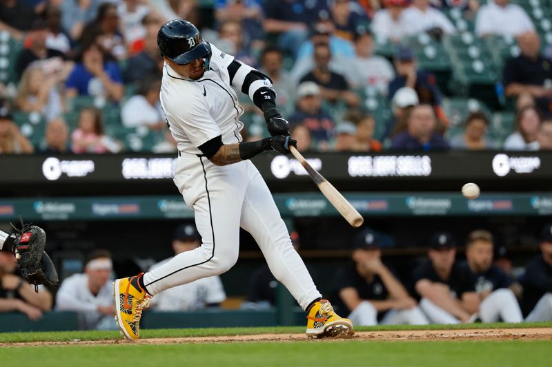 May 23, 2024; Detroit, Michigan, USA;  Detroit Tigers shortstop Javier Baez (28) hits a single in the sixth inning against the Toronto Blue Jays at Comerica Park. Mandatory Credit: Rick Osentoski-USA TODAY Sports