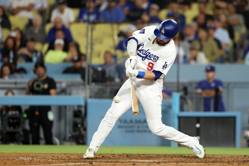 Sep 11, 2024; Los Angeles, California, USA;  Los Angeles Dodgers second baseman Gavin Lux (9) hits an RBI single during the seventh inning against the Chicago Cubs at Dodger Stadium. Mandatory Credit: Kiyoshi Mio-Imagn Images