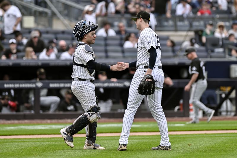 May 19, 2024; Bronx, New York, USA; New York Yankees catcher Jose Trevino (39) and New York Yankees pitcher Clay Holmes (35) shake hands after winning 7-2 against the Chicago White Sox at Yankee Stadium. Mandatory Credit: John Jones-USA TODAY Sports