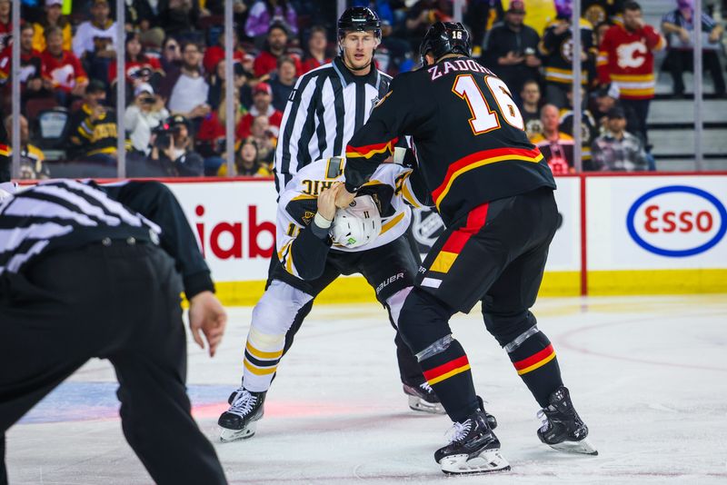 Feb 28, 2023; Calgary, Alberta, CAN; Boston Bruins center Trent Frederic (11) and Calgary Flames defenseman Nikita Zadorov (16) fight during the first period at Scotiabank Saddledome. Mandatory Credit: Sergei Belski-USA TODAY Sports