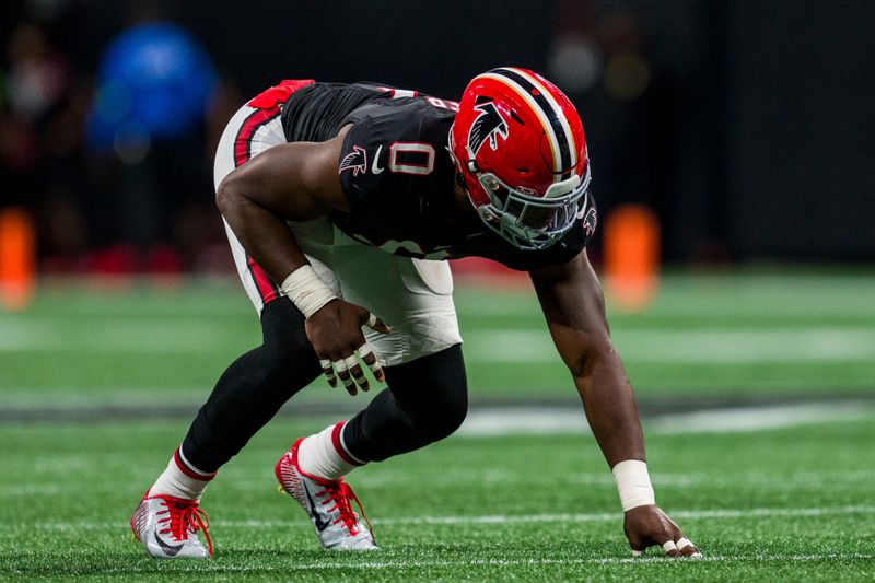 Atlanta Falcons linebacker Lorenzo Carter (0) lines up during the second half of an NFL football game against the Washington Commanders, Sunday, Oct. 15, 2023, in Atlanta. The Washington Commanders won 24-16. (AP Photo/Danny Karnik)