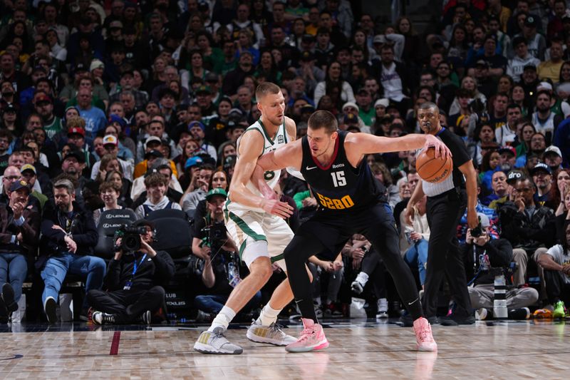 DENVER, CO - MARCH 7: Nikola Jokic #15 of the Denver Nuggets dribbles the ball during the game against the Boston Celtics on March 7, 2024 at the Ball Arena in Denver, Colorado. NOTE TO USER: User expressly acknowledges and agrees that, by downloading and/or using this Photograph, user is consenting to the terms and conditions of the Getty Images License Agreement. Mandatory Copyright Notice: Copyright 2024 NBAE (Photo by Garrett Ellwood/NBAE via Getty Images)