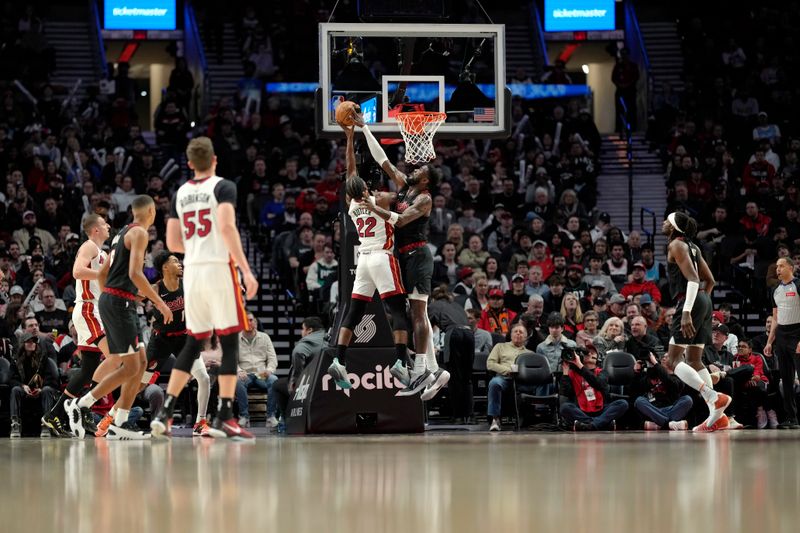 PORTLAND, OREGON - FEBRUARY 27: Jimmy Butler #22 of the Miami Heat has his shot blocked by Deandre Ayton #2 (R) of the Portland Trail Blazers during the first half at Moda Center on February 27, 2024 in Portland, Oregon. NOTE TO USER: User expressly acknowledges and agrees that, by downloading and or using this photograph, User is consenting to the terms and conditions of the Getty Images License Agreement. (Photo by Soobum Im/Getty Images)