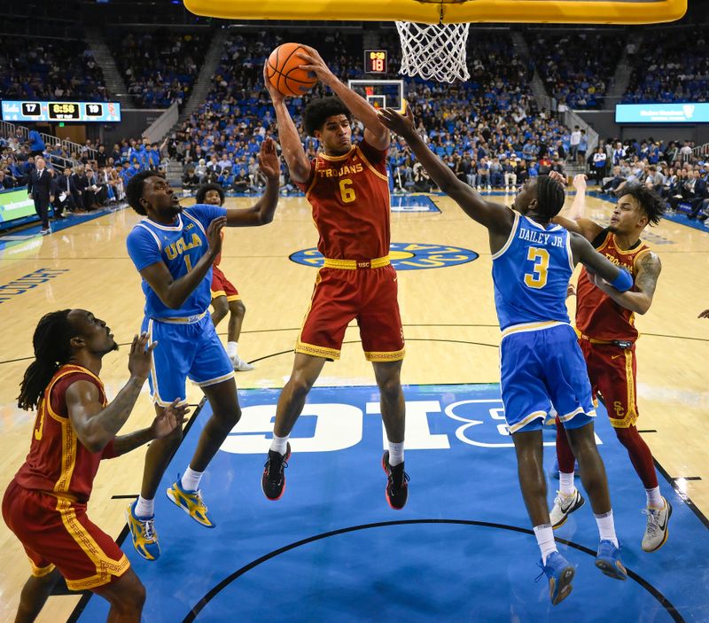 Feb 24, 2026; Los Angeles, California, USA;  Southern California Trojans forward Jacob Cofie (6) grabs a rebound between UCLA Bruins forward Xavier Booker (1) and guard Eric Dailey Jr. (3) during the first half at Pauley Pavilion presented by Wescom Financial. Mandatory Credit: Robert Hanashiro-Imagn Images