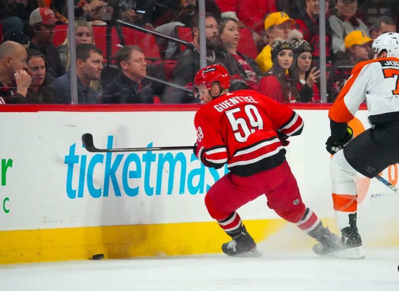 Mar 21, 2024; Raleigh, North Carolina, USA; Carolina Hurricanes left wing Jake Guentzel (59) skates with the puck against the Philadelphia Flyers during the second period at PNC Arena. Mandatory Credit: James Guillory-USA TODAY Sports