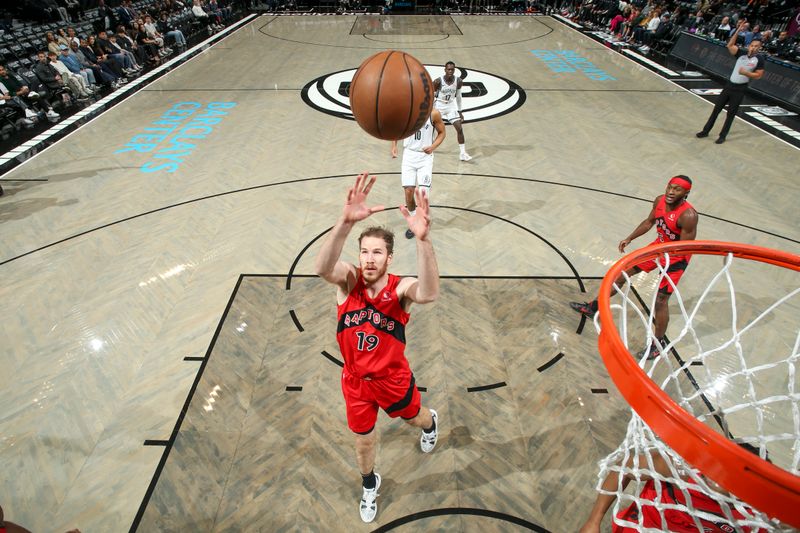 BROOKLYN, NY - OCTOBER 18: Jakob Poeltl #19 of the Toronto Raptors rebounds the ball during the game on October 18, 2024 at Barclays Center in Brooklyn, New York. NOTE TO USER: User expressly acknowledges and agrees that, by downloading and or using this Photograph, user is consenting to the terms and conditions of the Getty Images License Agreement. Mandatory Copyright Notice: Copyright 2024 NBAE (Photo by Nathaniel S. Butler/NBAE via Getty Images)