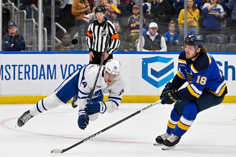 Feb 19, 2024; St. Louis, Missouri, USA;  Toronto Maple Leafs center Bobby McMann (74) shoots and scores and empty net goal against the St. Louis Blues during the third period at Enterprise Center. Mandatory Credit: Jeff Curry-USA TODAY Sports