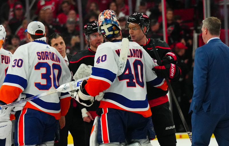 Apr 30, 2024; Raleigh, North Carolina, USA; New York Islanders goaltender Semyon Varlamov (40) shakes hands with Carolina Hurricanes center Evgeny Kuznetsov (92) and center Jack Drury (18) after the game in game five of the first round of the 2024 Stanley Cup Playoffs at PNC Arena. Mandatory Credit: James Guillory-USA TODAY Sports